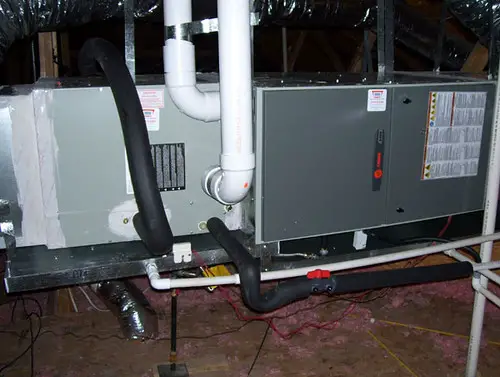 Trane air conditioning and heating unit in attic - pipes
